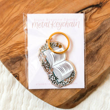 Load image into Gallery viewer, Floral Book Metal Keychain 2x2 in.